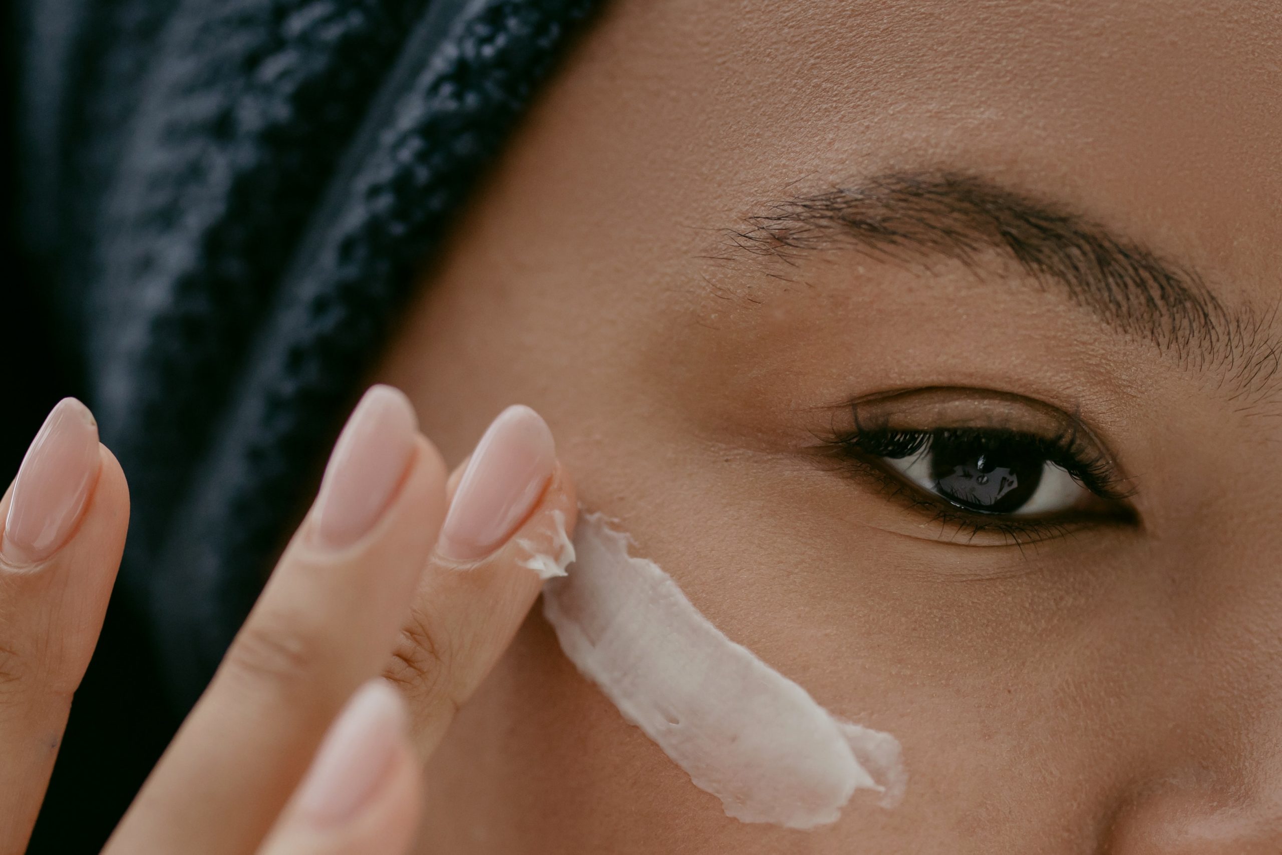 Photo by cottonbro: https://www.pexels.com/photo/woman-applying-facial-cream-on-face-6635929/